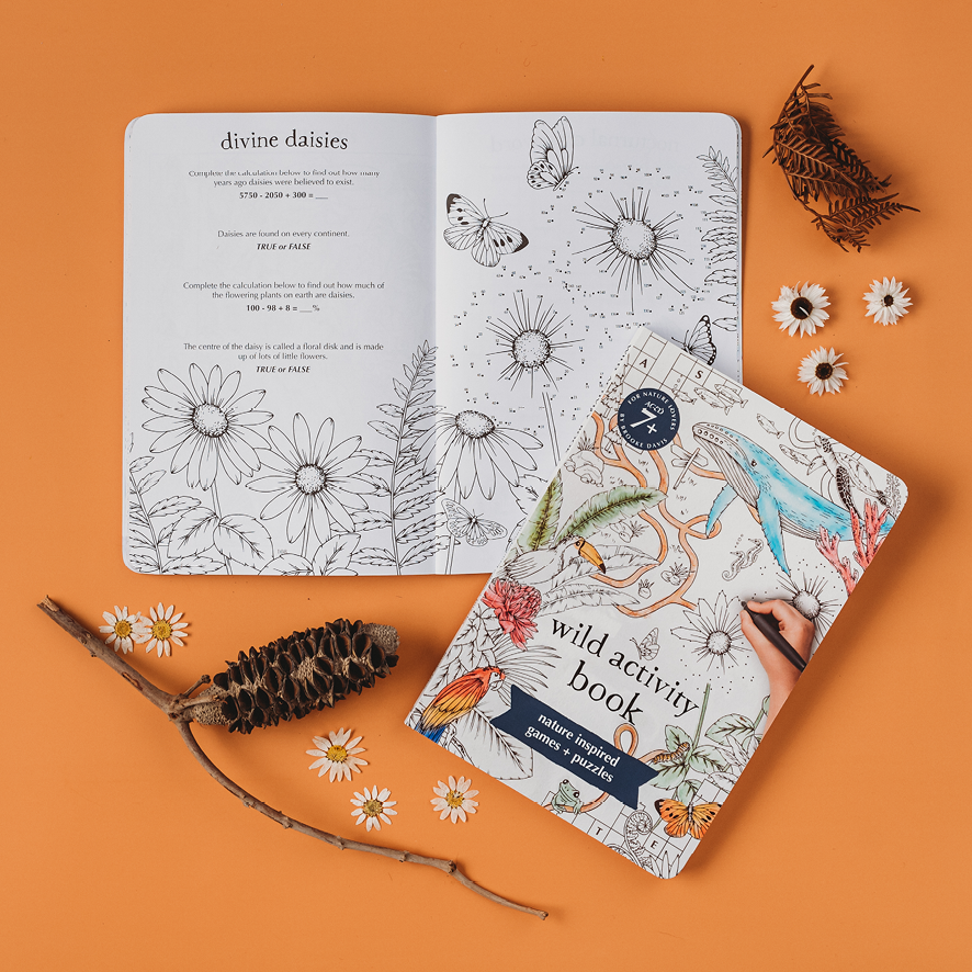 Open activity book with nature-themed illustrations on an orange background