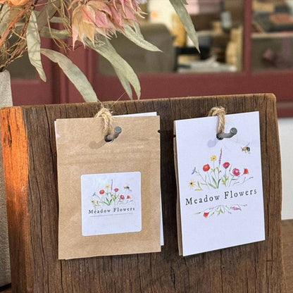 Meadow Flowers packaging displayed on a rustic wooden stand with Meadow Flowers branding. Ideal for shaded garden areas.