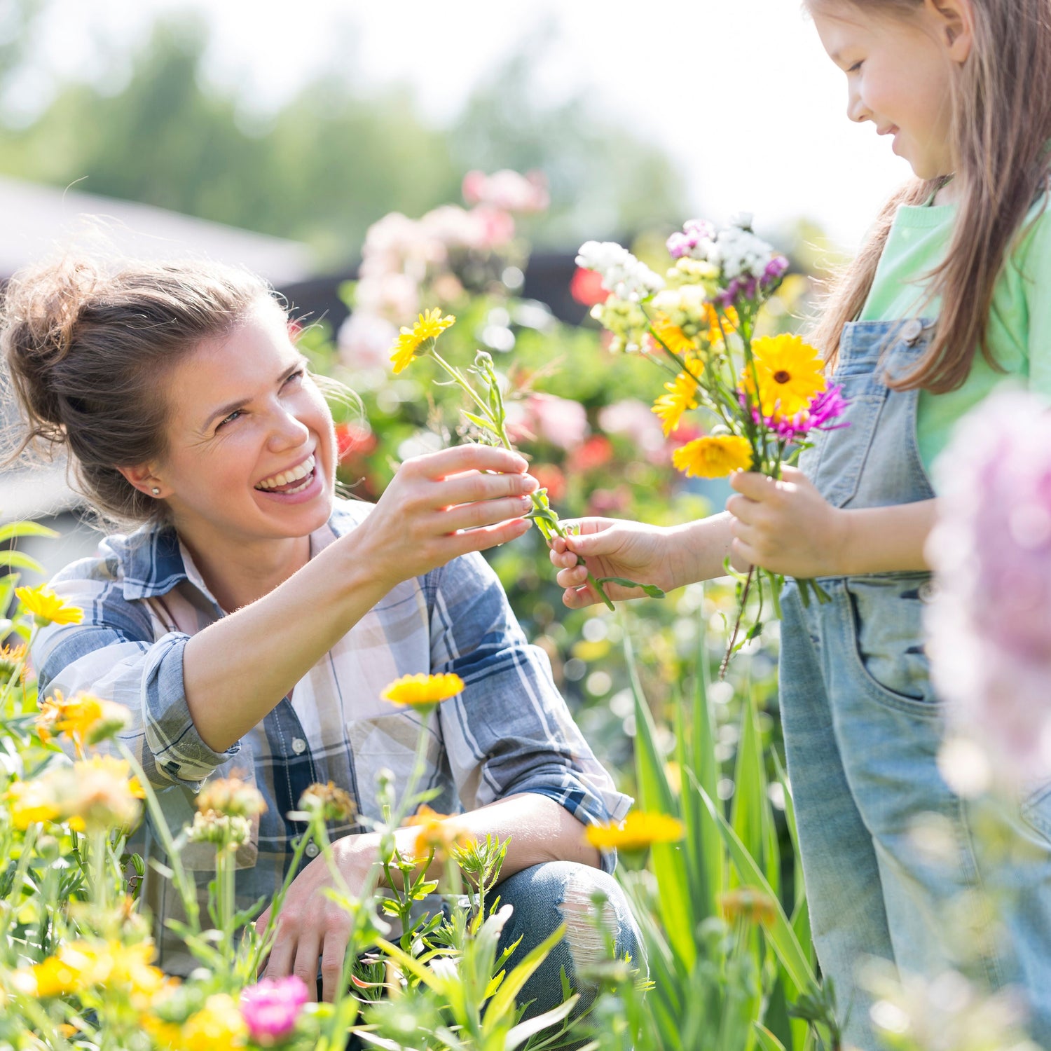 Woman and child in a garden holding flowers